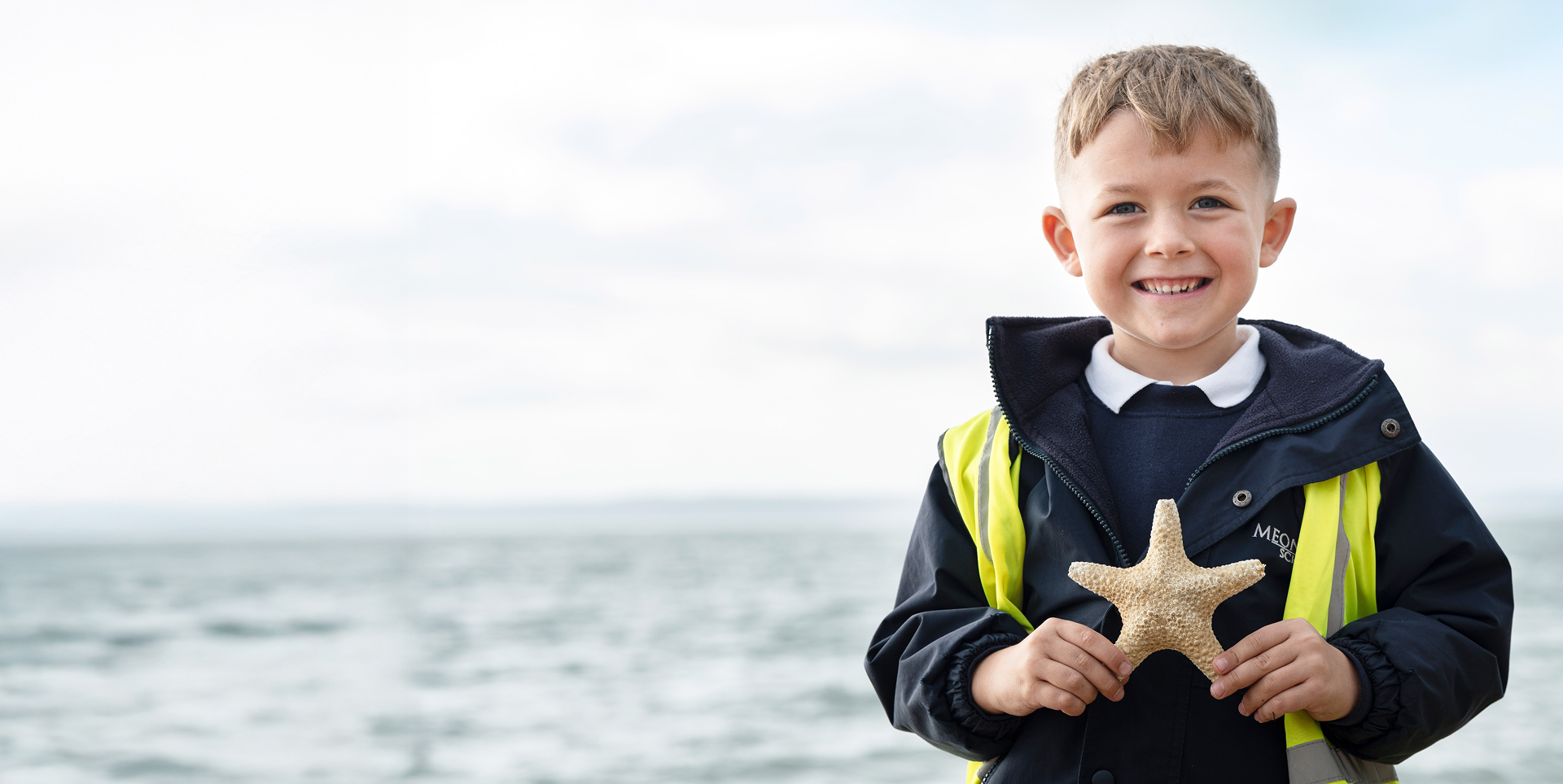 Child holding starfish